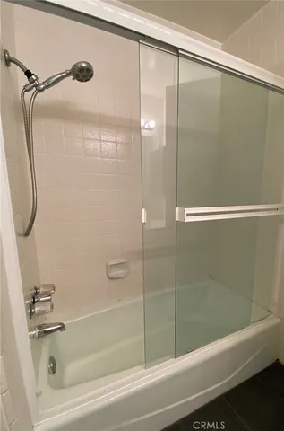 a bathroom with a shower and a bathtub
