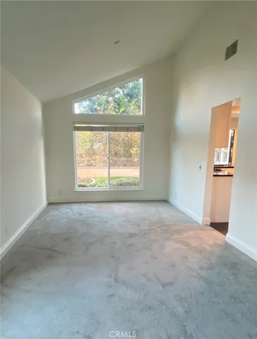 an empty room with windows and an outdoor view