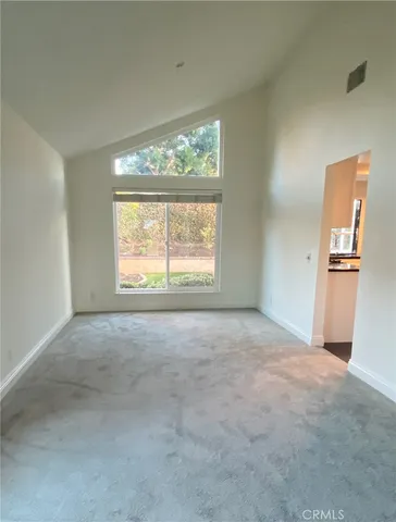 an empty room with windows and an outdoor view