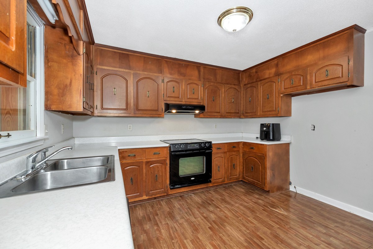 2117 Ardmore Highway Ardmore, TN 38449 - Photo 13 of 32 a kitchen with stainless steel appliances granite countertop a sink a stove and a microwave oven