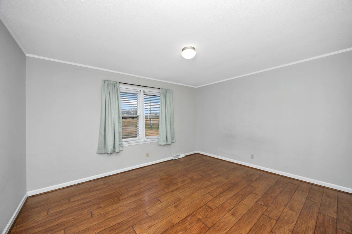 2117 Ardmore Highway Ardmore, TN 38449 - Photo 17 of 32 an empty room with wooden floor and windows