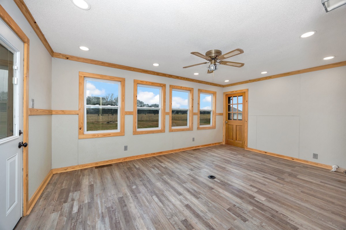 2117 Ardmore Highway Ardmore, TN 38449 - Photo 22 of 32 a view of an empty room with a window and wooden floor