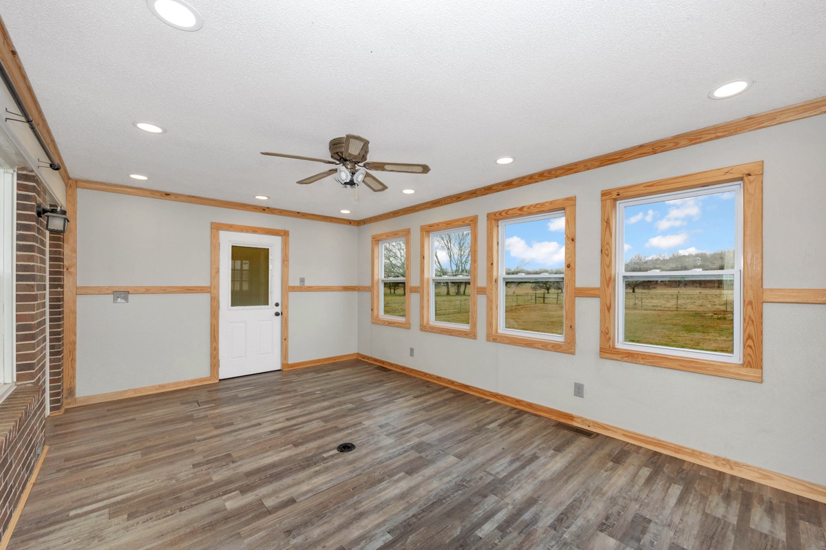 2117 Ardmore Highway Ardmore, TN 38449 - Photo 23 of 32 a view of an empty room with a window and wooden floor