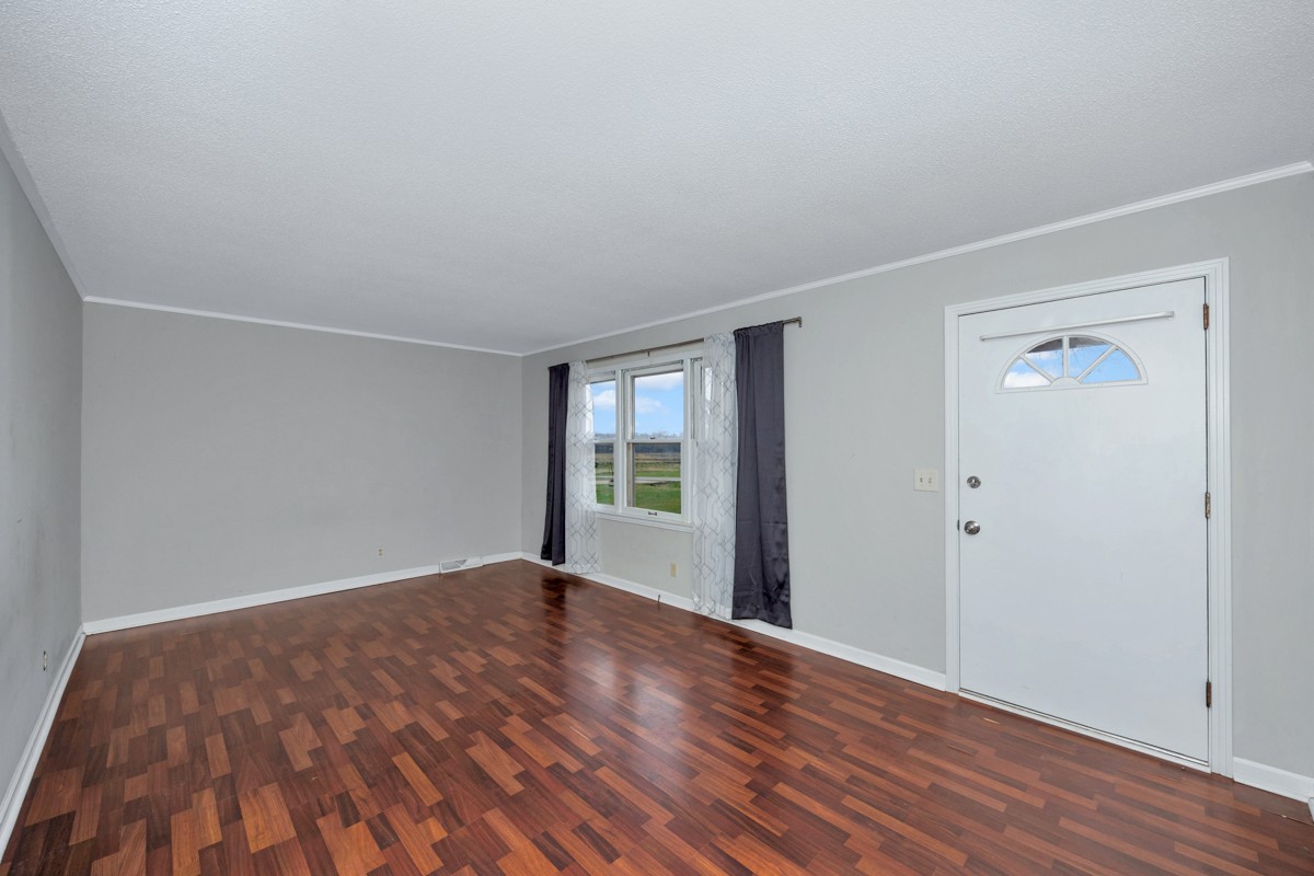 2117 Ardmore Highway Ardmore, TN 38449 - Photo 4 of 32 a view of an empty room with wooden floor and a window