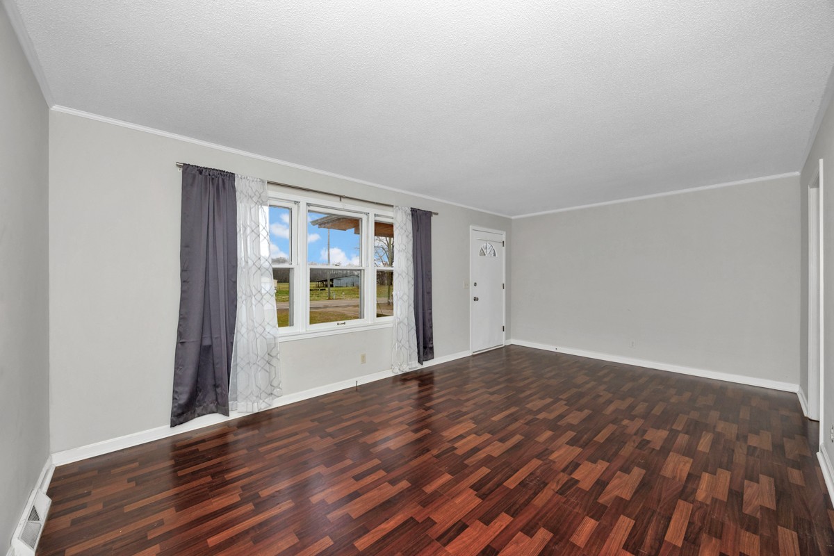 2117 Ardmore Highway Ardmore, TN 38449 - Photo 5 of 32 a view of an empty room with wooden floor and a window