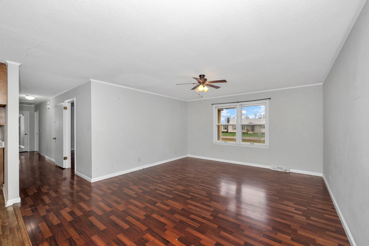 2117 Ardmore Highway Ardmore, TN 38449 - Photo 7 of 32 a view of an empty room with wooden floor and a window