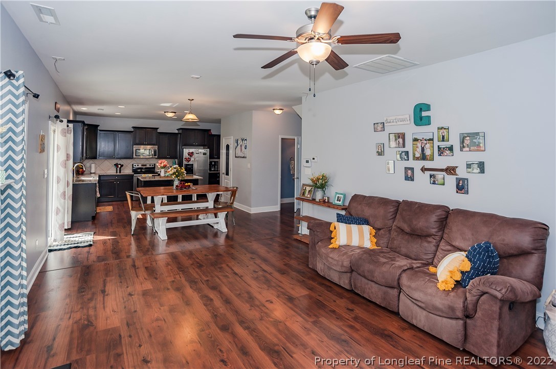 461 St Johns Loop Raeford, NC 28376 - Photo 16 of 50 a living room with furniture and kitchen view