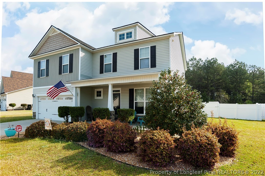 461 St Johns Loop Raeford, NC 28376 - Photo 2 of 50 a front view of a house with a yard and potted plants