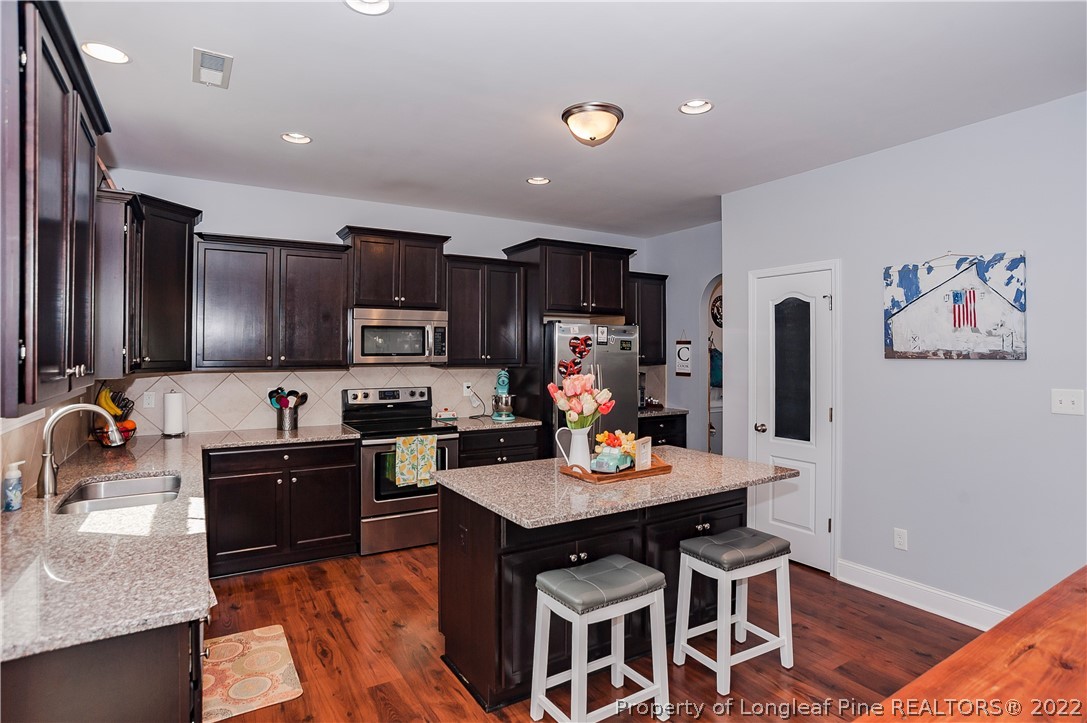 461 St Johns Loop Raeford, NC 28376 - Photo 22 of 50 a kitchen with cabinets a sink and appliances