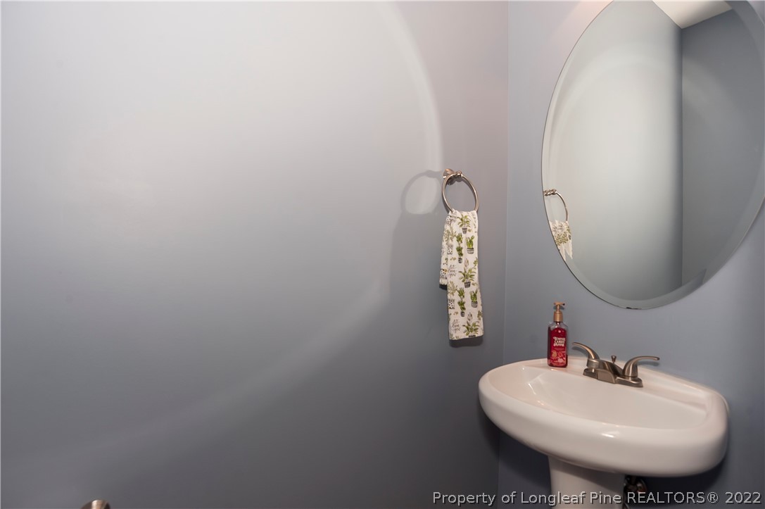 461 St Johns Loop Raeford, NC 28376 - Photo 26 of 50 a bathroom with a sink a mirror and vanity