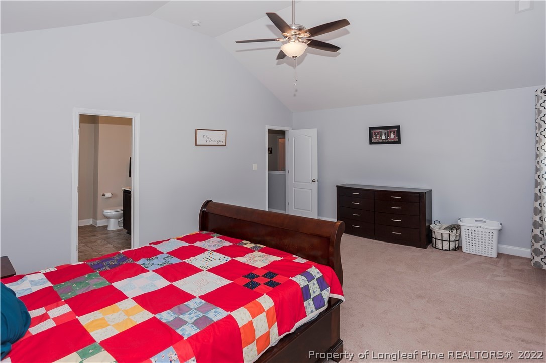 461 St Johns Loop Raeford, NC 28376 - Photo 33 of 50 a bedroom with a bed and a chandelier