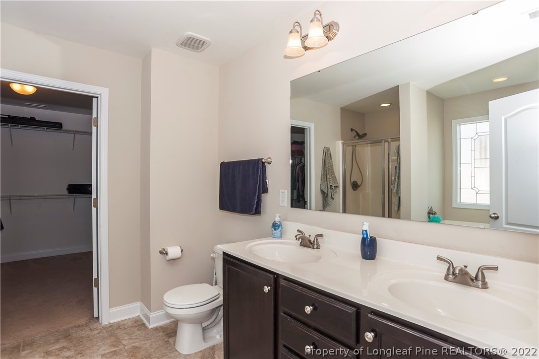 461 St Johns Loop Raeford, NC 28376 - Photo 34 of 50 a bathroom with a sink double vanity and a toilet