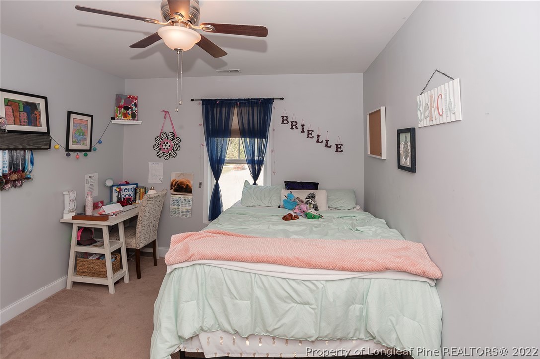 461 St Johns Loop Raeford, NC 28376 - Photo 50 of 50 a bedroom with a bed and a chandelier