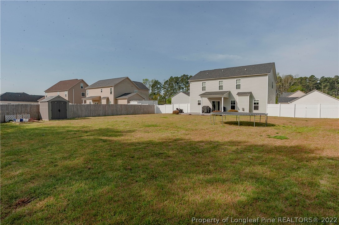 461 St Johns Loop Raeford, NC 28376 - Photo 7 of 50 a large house with a big yard and large trees
