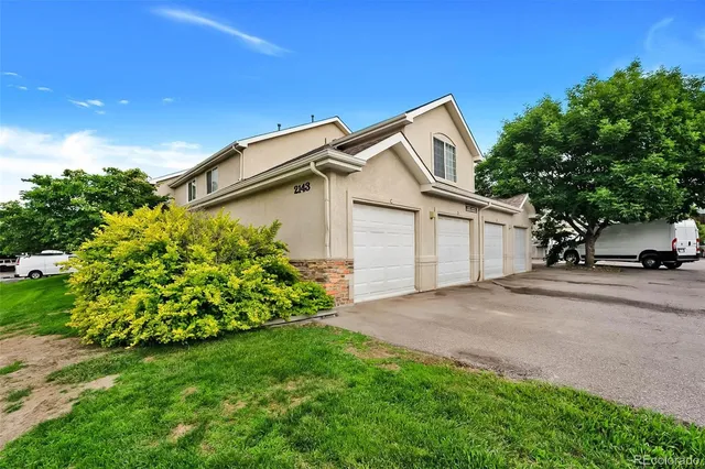 a view of a house with a yard and garage