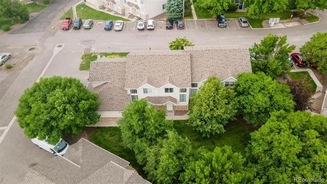 an aerial view of a house with a yard and garden