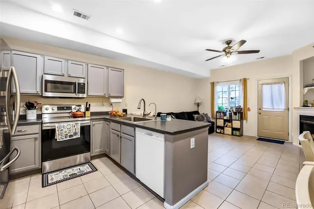 a kitchen with stainless steel appliances granite countertop a stove a sink and a refrigerator