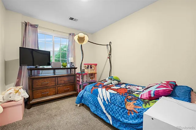 a bedroom with a bed and flat screen tv