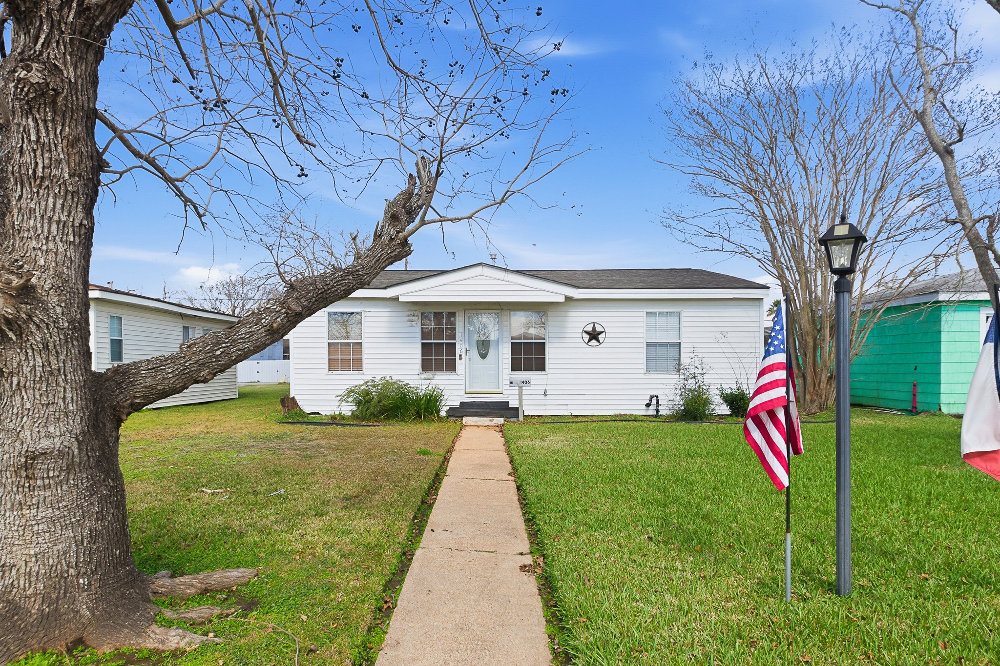 1406 West 6th Street Freeport, TX 77541 - Photo 1 of 25 a view of a house with a back yard
