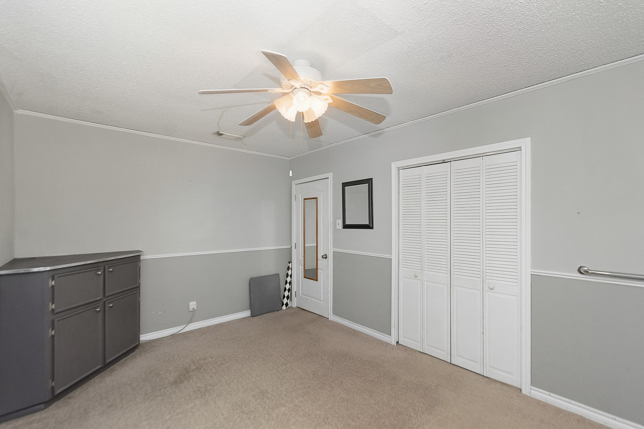 1406 West 6th Street Freeport, TX 77541 - Photo 12 of 25 a view of a livingroom with an empty space and a ceiling fan