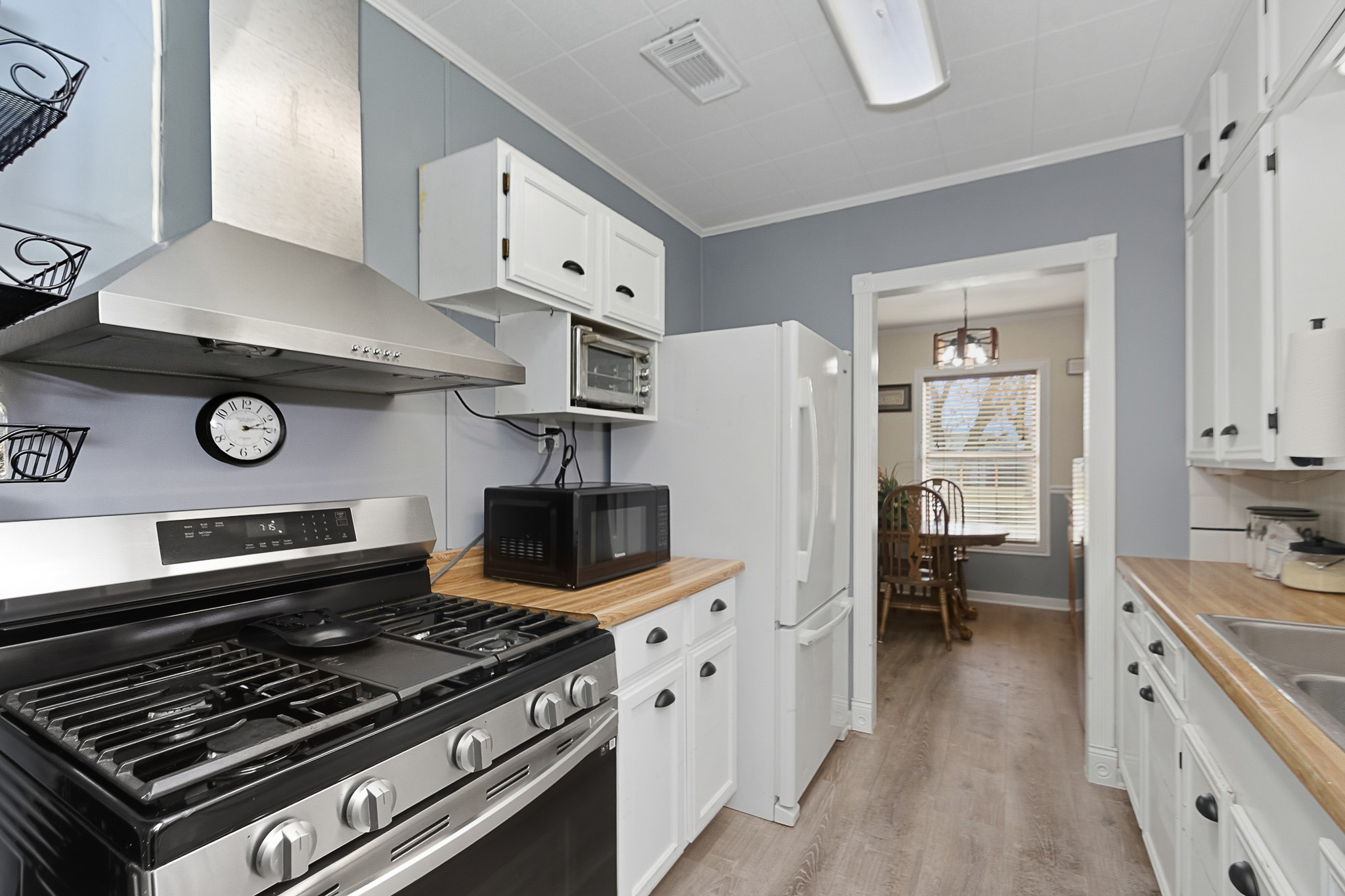 1406 West 6th Street Freeport, TX 77541 - Photo 4 of 25 a kitchen with a stove and a refrigerator