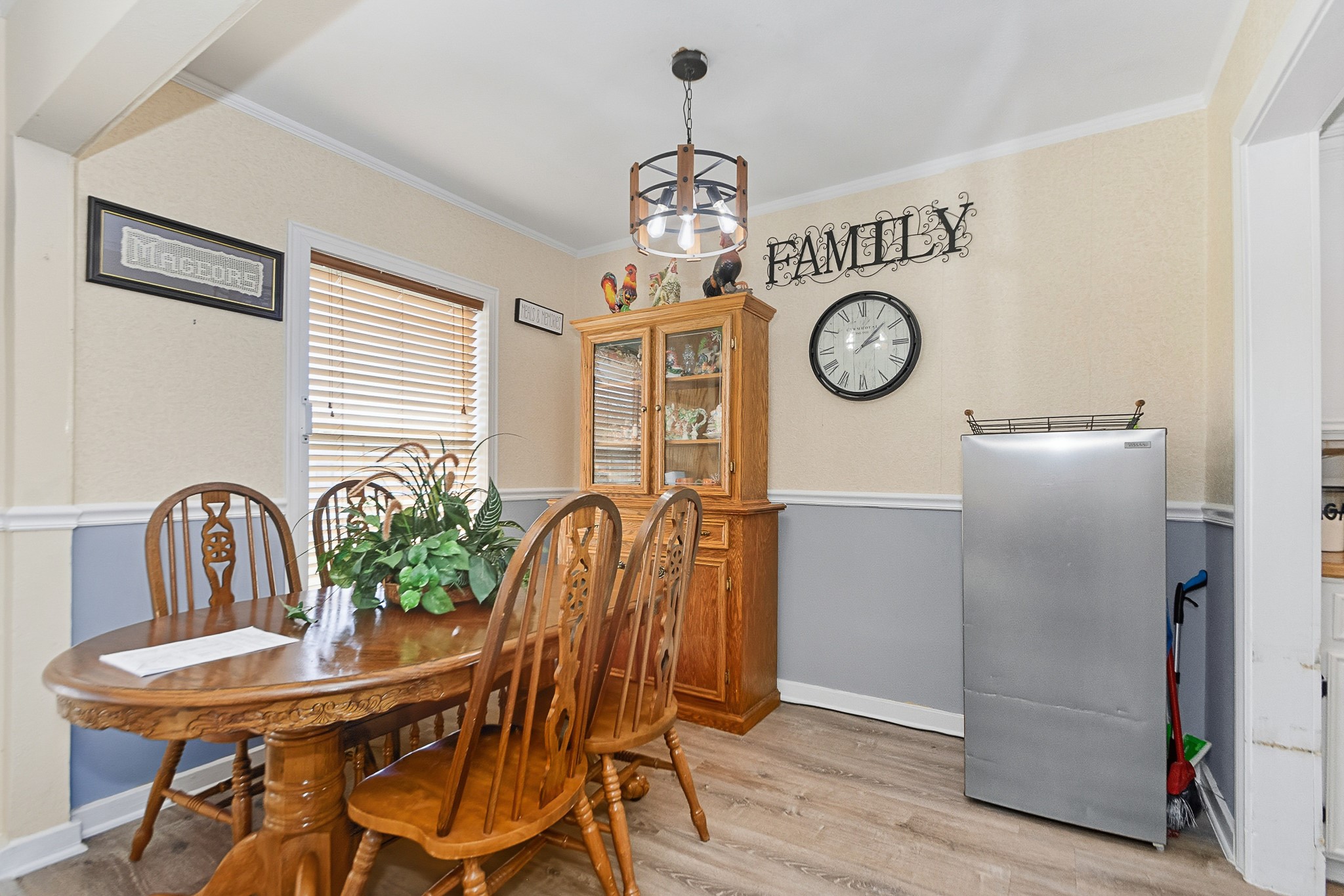 1406 West 6th Street Freeport, TX 77541 - Photo 9 of 25 a view of a dining room with furniture wooden floor and a clock