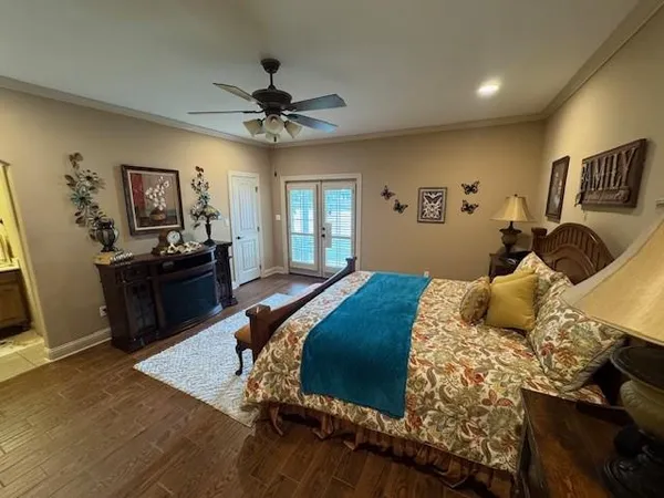 a bedroom with a bed and wooden floor