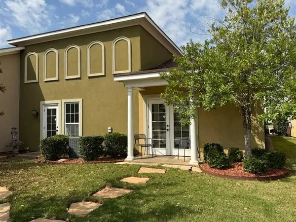 a front view of a house with a yard