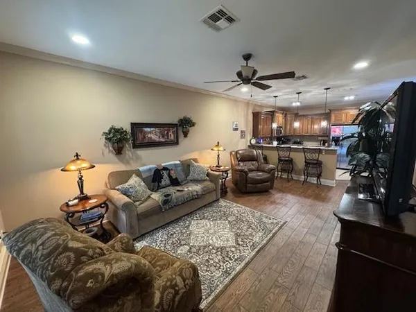 a living room with furniture and a wooden floor