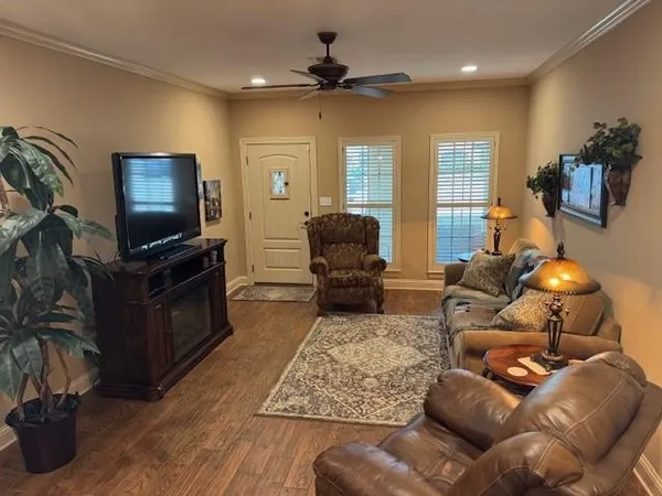 a kitchen with granite countertop stainless steel appliances a sink stove refrigerator and cabinets