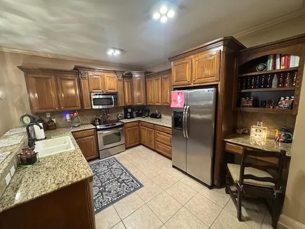 a kitchen with a sink stove and refrigerator