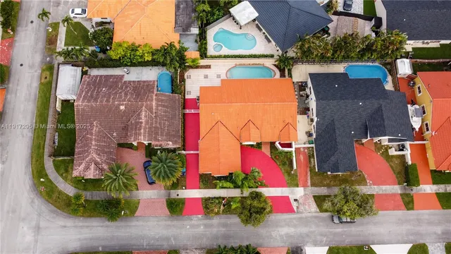 an aerial view of residential house with outdoor space and parking