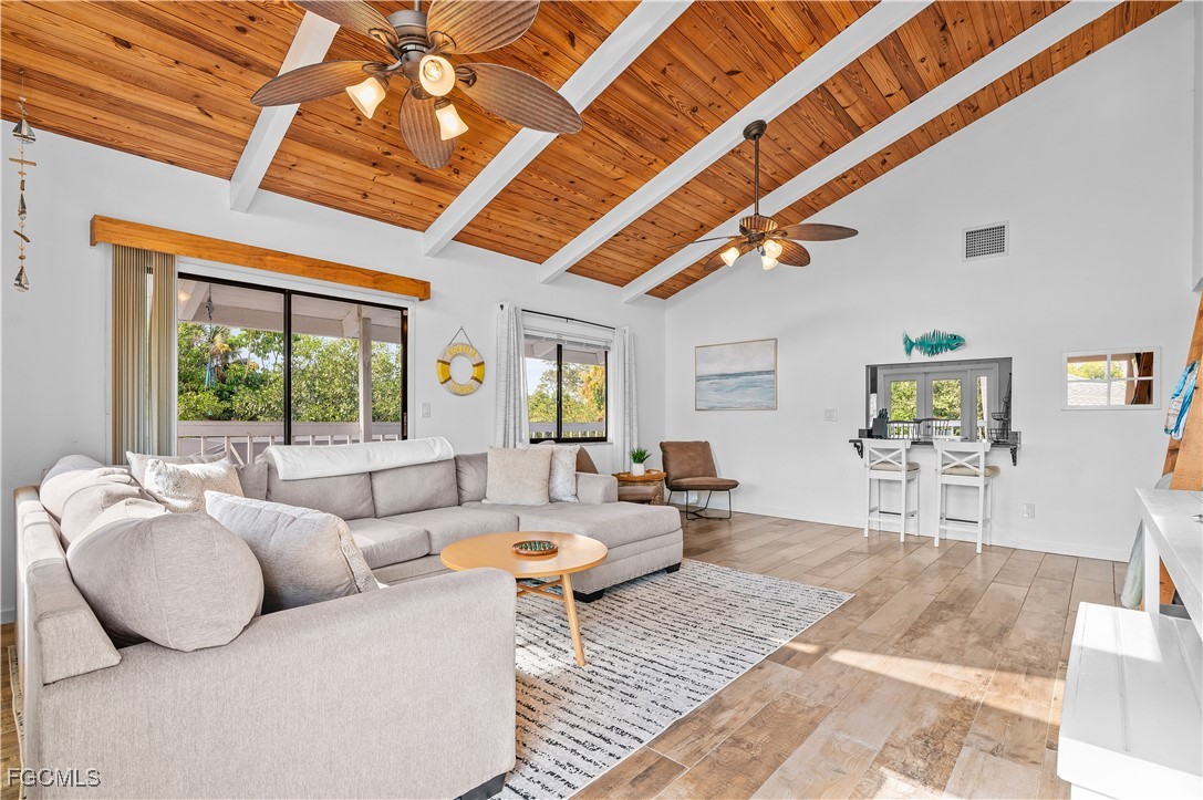 14171 Bokeelia Road Bokeelia, FL 33922 - Photo 12 of 25 a living room with furniture and a large window