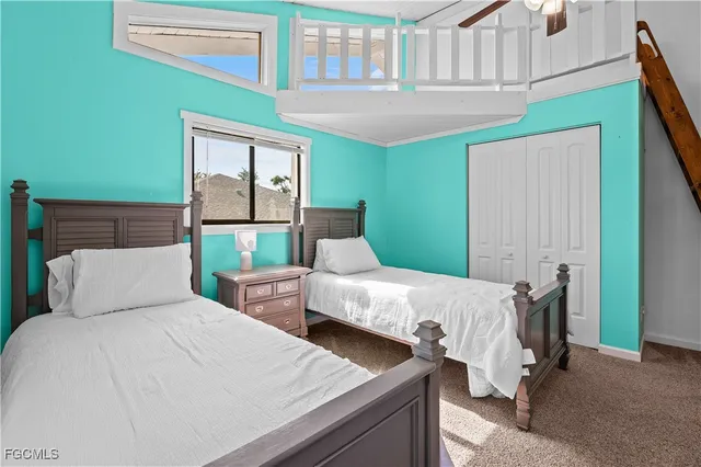 a bedroom with two beds and a window