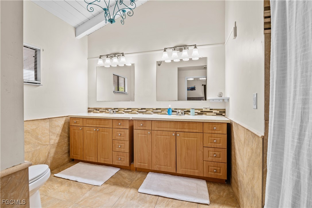 14171 Bokeelia Road Bokeelia, FL 33922 - Photo 20 of 25 a spacious bathroom with a granite countertop sink and a mirror