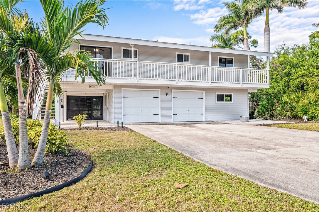 14171 Bokeelia Road Bokeelia, FL 33922 - Photo 2 of 25 a front view of a house with garden