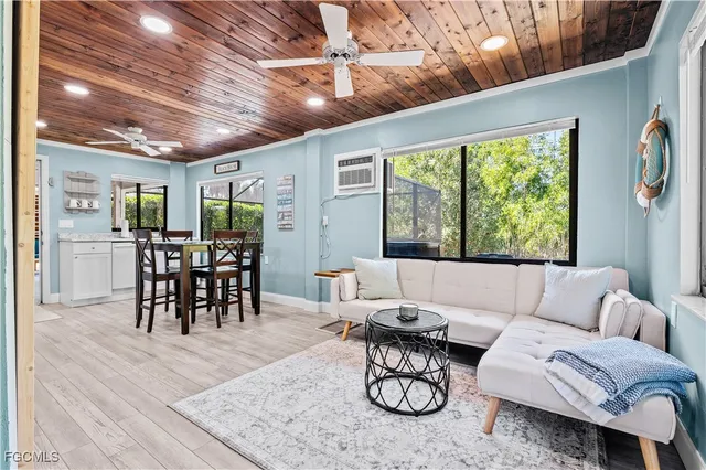 a living room with furniture a dining table and a large window