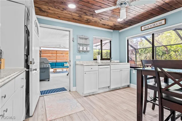 a kitchen with a sink appliances and cabinets
