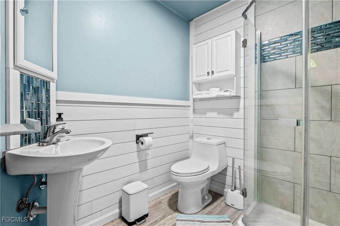 14171 Bokeelia Road Bokeelia, FL 33922 - Photo 8 of 25 a bathroom with a toilet sink and shower