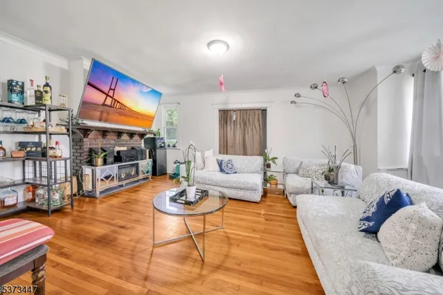 a living room with furniture and a dining table