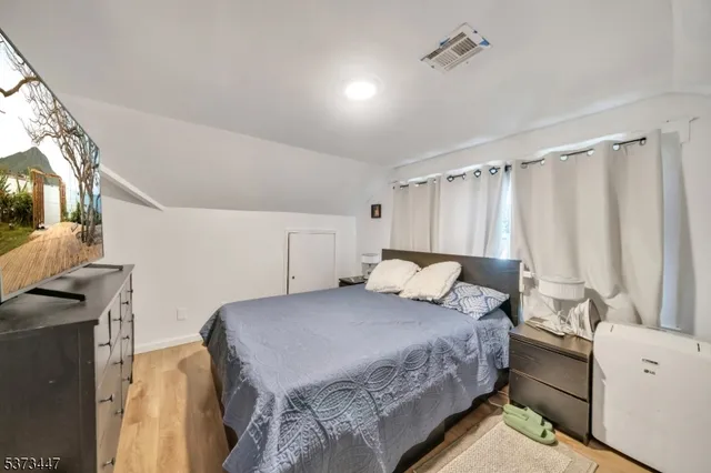 a bedroom with a bed and a tv