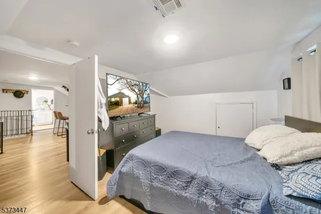 a bedroom with a bed and a view of bathroom