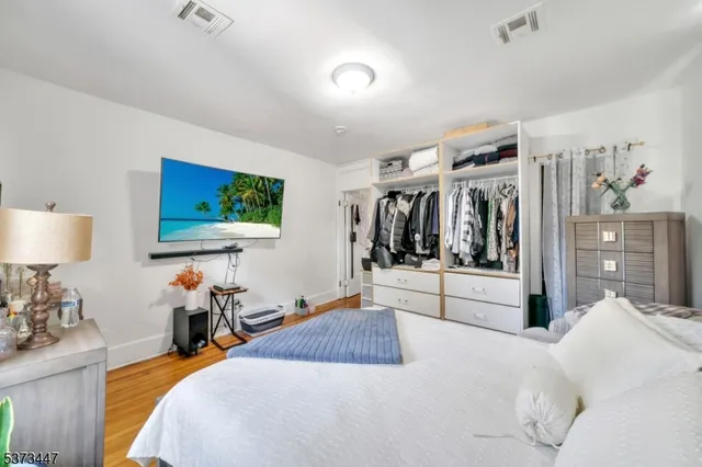 a bedroom with furniture and a flat screen tv