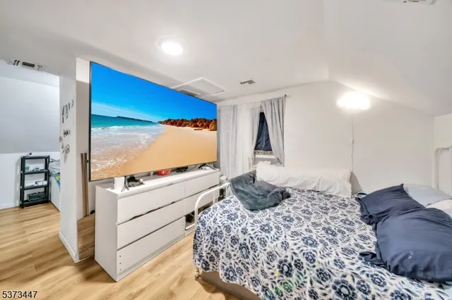 a bedroom with a bed and a large window