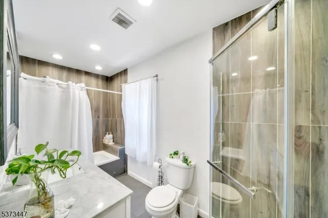 a bathroom with a shower curtain and a toilet