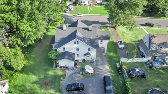 an aerial view of multiple houses with yard