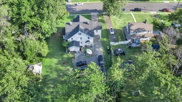 an aerial view of multiple houses with yard