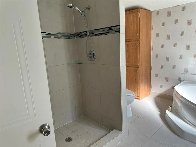 a bathroom with a shower and a sink