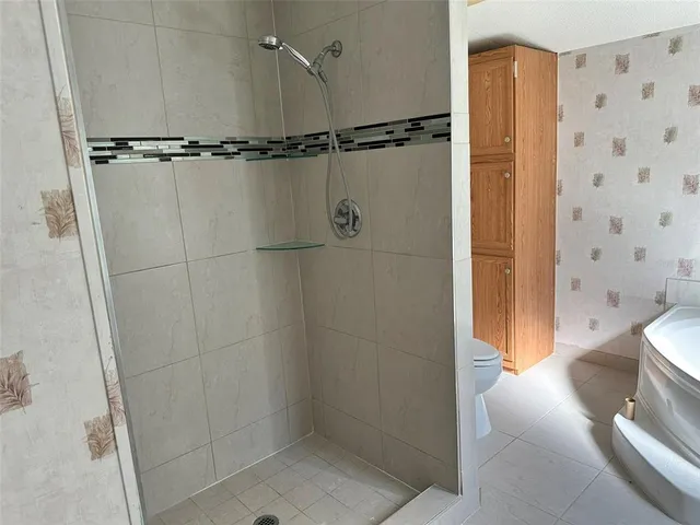 a bathroom with a shower and a toilet