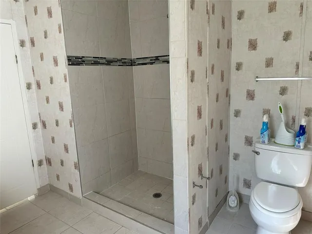 a bathroom with a shower and a toilet